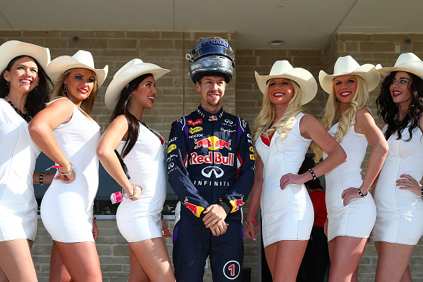 AUSTIN, TX - NOVEMBER 02: Sebastian Vettel of Germany and Infiniti Red Bull Racing poses with grid girls before the United States Formula One Grand Prix at Circuit of The Americas on November 2, 2014 in Austin, United States. (Photo by Mark Thompson/Getty Images)